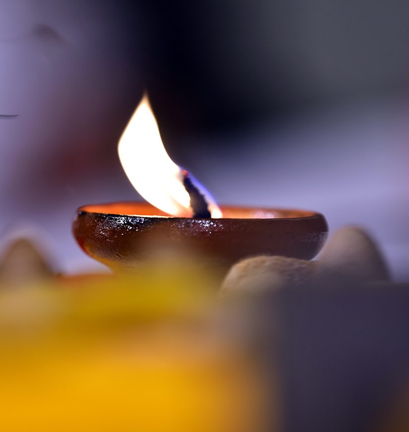 Diya lamp with fire. Traditional hindu Diwali festival. bokeh background